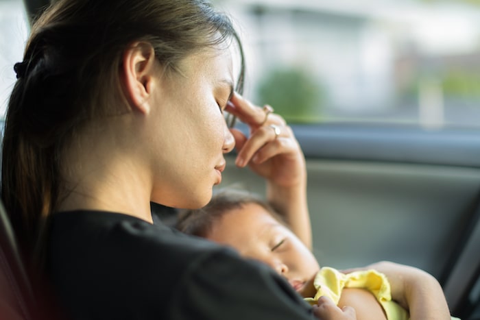 stressed mom holding child