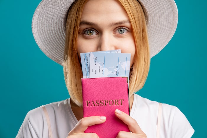 woman holding passport excited