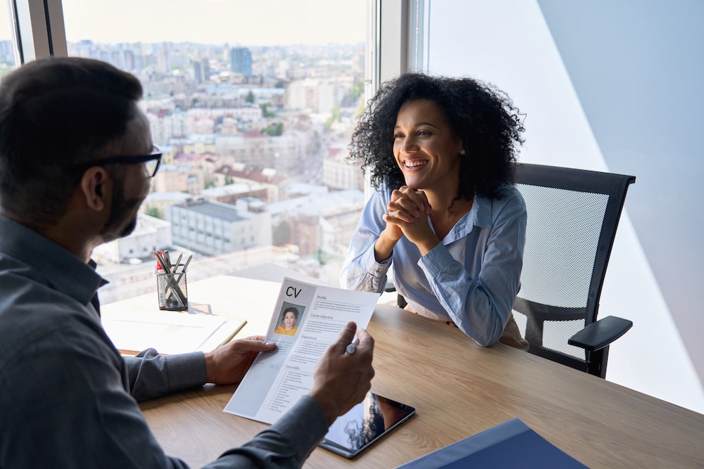 man and woman talking in office